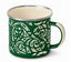 A green enamel camp mug with a cream-colored Maori-inspired tribal pattern, cream interior, and a silver metal rim, shown on a white background.