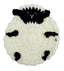 A round, hand-crocheted sheep-shaped item, likely a coaster or decorative mat, featuring a textured off-white body with black yarn details for the face, ears, and markings.
