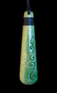 Greenstone pendant with intricate carvings on a black background