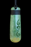 Greenstone pendant with spiral design on a black background