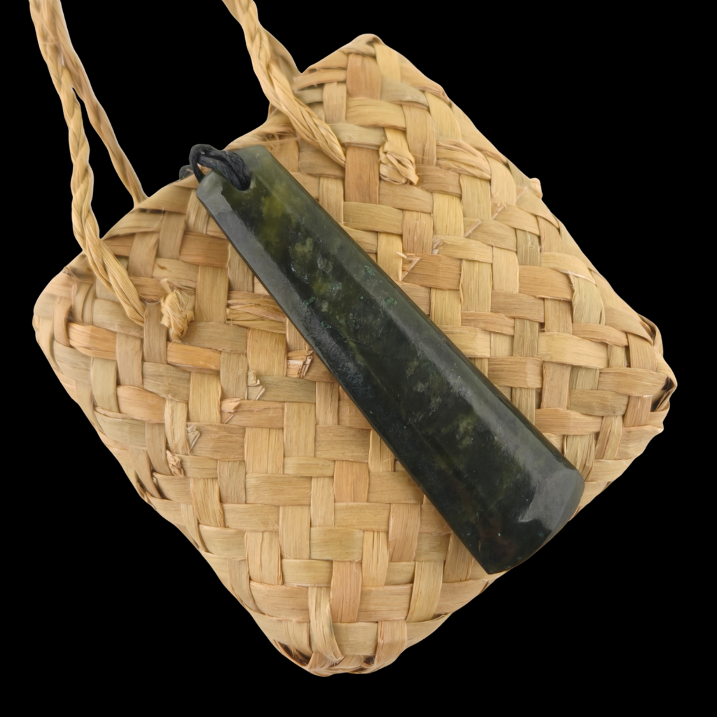 Woven bag with a black cylindrical object on a clear background