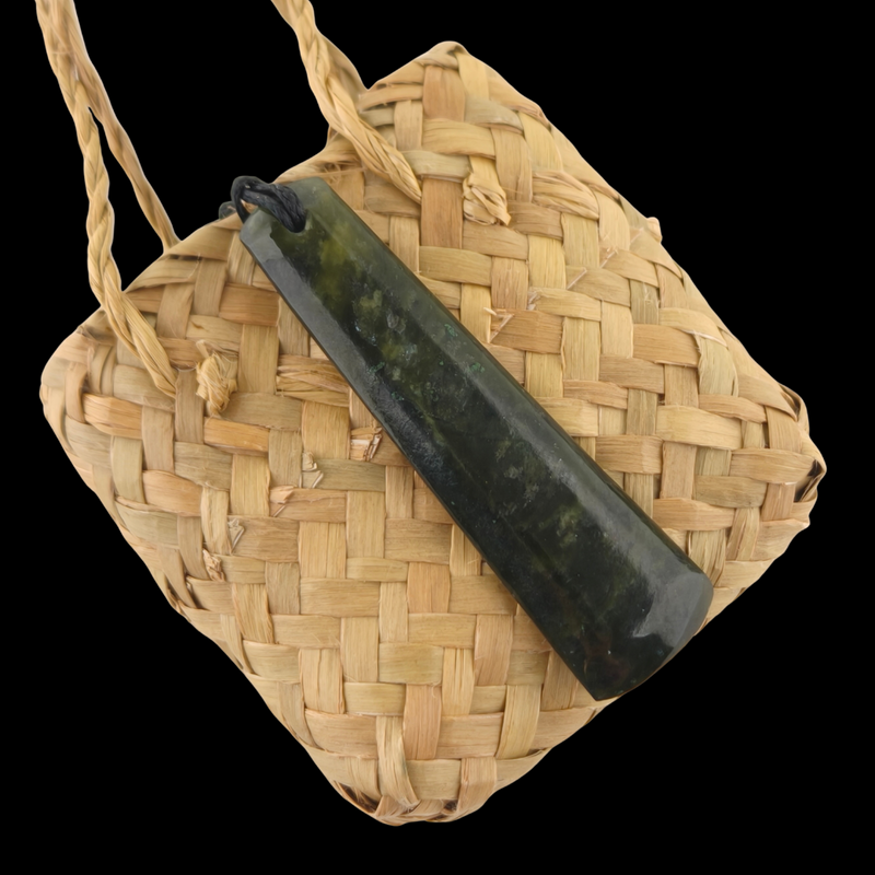 Woven bag with a black cylindrical object on a clear background