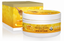 A jar of Manuka Honey Revitalising SPF30 Day Creme alongside its packaging box, both featuring a golden-yellow and white design with illustrations of honeycomb and a honey dipper.