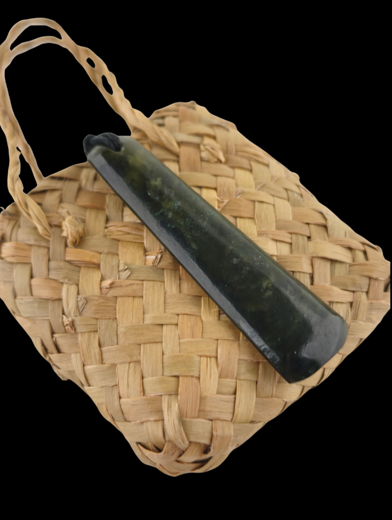 Woven basket with a black tool on a clear background