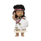 Doll dressed in traditional attire with a headdress and feathered garment on a white background