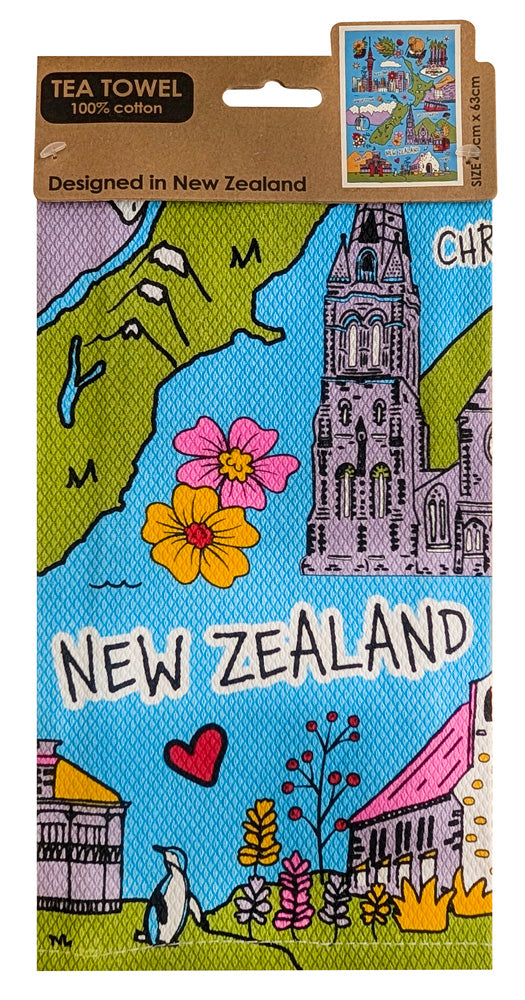 A rectangular tea towel featuring a colorful illustrated New Zealand map and landmarks, hanging from a brown cardboard hanger. The design includes blue water, green land, pink and yellow flowers, a gray tower, and the words 'NEW ZEALAND' across the center.