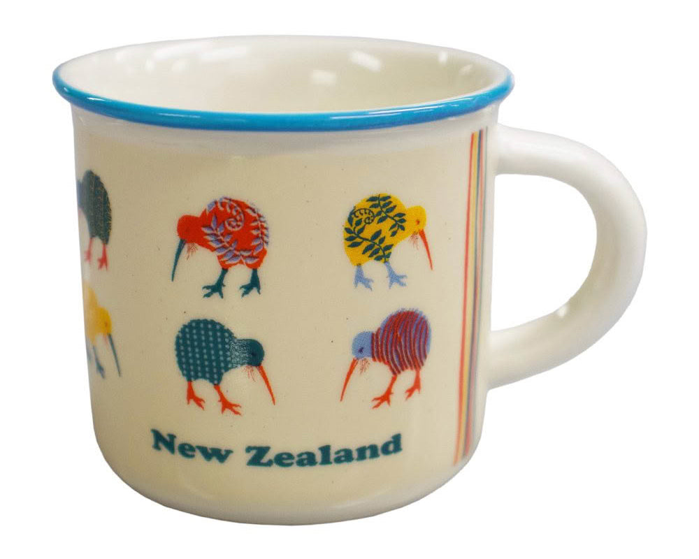 A cream-colored enamel mug with a blue rim, decorated with colorful kiwi birds and the text 'New Zealand' on the front. Main image