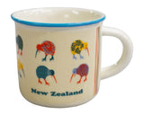A cream-colored enamel mug with a blue rim, decorated with colorful kiwi birds and the text 'New Zealand' on the front.