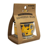 A New Zealand Espresso Mug in its original brown kraft paper packaging. The mug features a bright yellow body with black sheep illustrations and a black rim, with the word 'NEW ZEALAND' printed on the base.