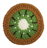 A crocheted kiwifruit slice coaster or decorative piece featuring concentric rings of brown, green, white, and dark brown seeds on a plain white background.