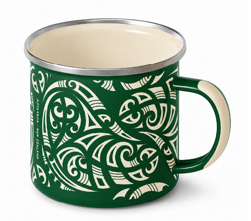 A green enamel camp mug with a cream-colored Maori-inspired tribal pattern, cream interior, and a silver metal rim, shown on a white background. Main image