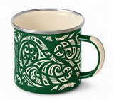 A green enamel camp mug with a cream-colored Maori-inspired tribal pattern, cream interior, and a silver metal rim, shown on a white background.