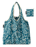 A reusable tote bag with a teal and cream maori tribal swirl pattern, shown alongside its matching carrying pouch on a solid white background.