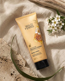 Wild Ferns New Zealand Manuka Honey Body Lotion on a textured surface with flowers and leaves.