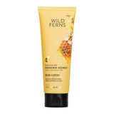 Yellow tube of Wild Ferns Manuka Honey body lotion on a white background
