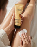 Person applying Wild Ferns Manuka Honey body lotion to their arm.