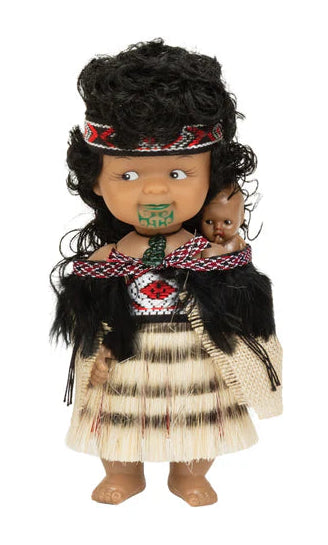 Doll dressed in traditional Maori attire with a white background