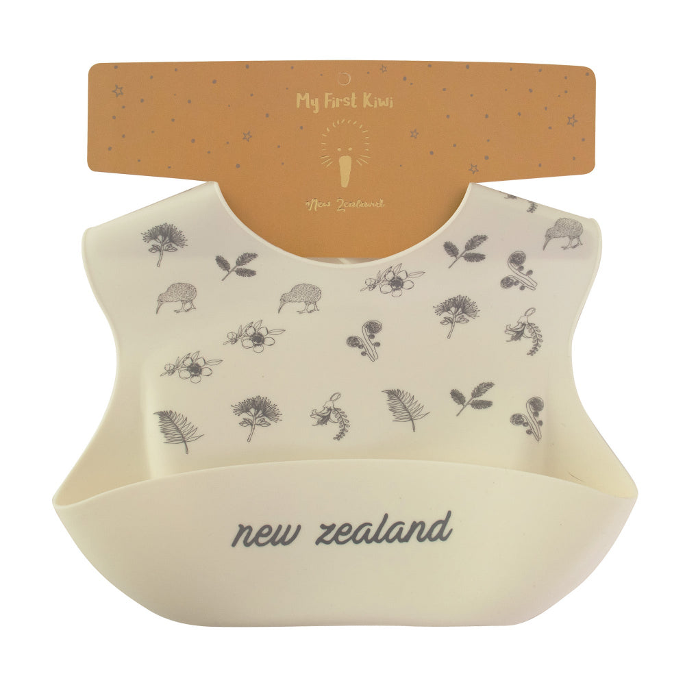 Baby bib with nature-themed print and 'New Zealand' text on a white background