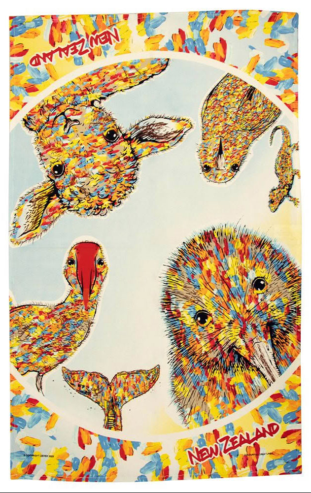 A printed tea towel featuring colorful New Zealand animal illustrations, including a kiwi, rabbit, duck, and seal, arranged inside a circular frame with a multicolored abstract border. The words "New Zealand" appear in red near the top and bottom.