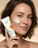 Woman applying facial moisturizer with a product labeled 'Wild Ferris' on a beige background