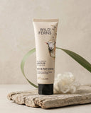 Tube of Wild Ferns hand and nail crème on a wooden surface with a natural background