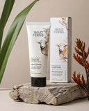 Wild Ferns hand cream and packaging on a wooden surface with plants in the background