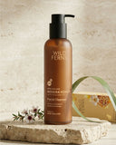 Brown bottle of Wild Ferns Manuka Honey Facial Cleanser on a stone surface with a natural background