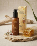 Wild Ferns Manuka Honey skincare product on a stone surface with honeycomb and flowers.