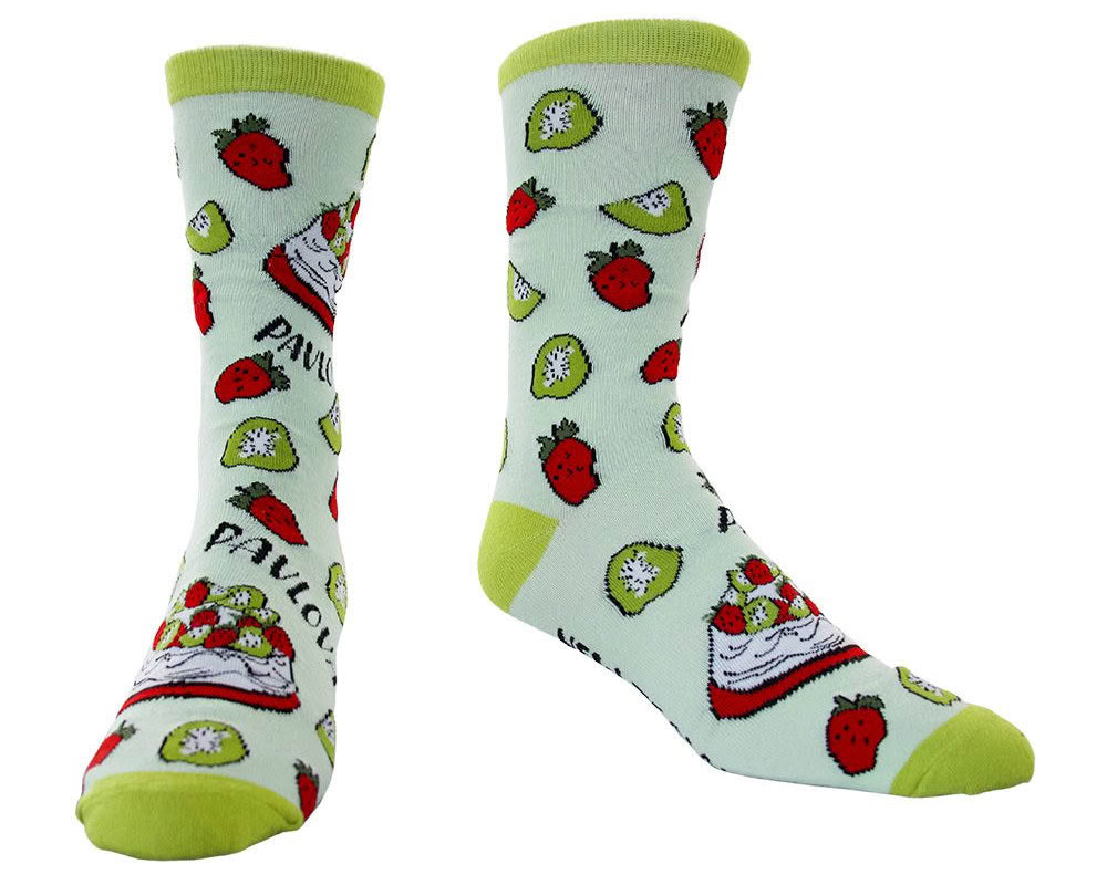 A pair of crew socks with a light mint green base, featuring a repeating pattern of red strawberries, green kiwi slices, and red-and-white strawberry cake slices, with lime green heels, toes, and cuffs.