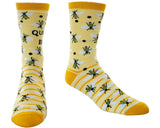 A pair of crew socks with a yellow and white striped pattern, decorated with black and yellow bee motifs and the text 'QUEEN BEE'.