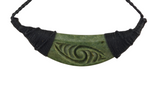 A green carved stone pendant necklace with a spiral motif, wrapped in black cord on both sides, shown against a plain white background.