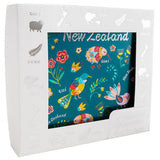 White photo frame with New Zealand-themed design on a white background