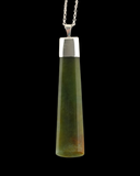 A faceted green stone pendant necklace with a polished silver cap and a silver chain, shown against a solid black background.
