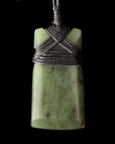 Green stone pendant with woven design on a black background