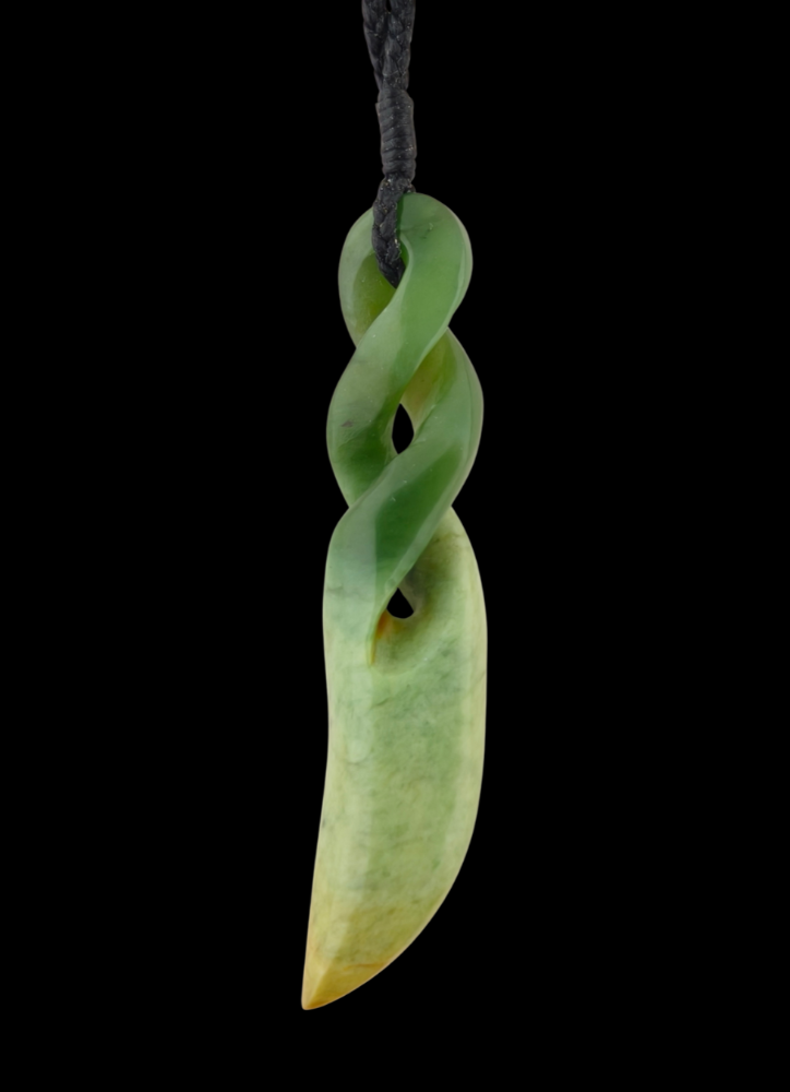 Green jade pendant with a twisted design on a black background