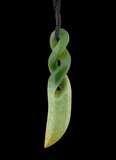 Green jade pendant with a twisted design on a black background