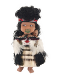 Doll dressed in traditional attire with a white background
