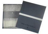 Gray scarf with packaging displaying 'Made in New Zealand' text