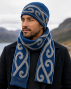 Blue Koru Beanie on a man with hills in the background