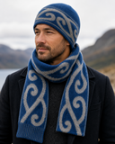 Blue Koru Beanie on a man with hills in the background