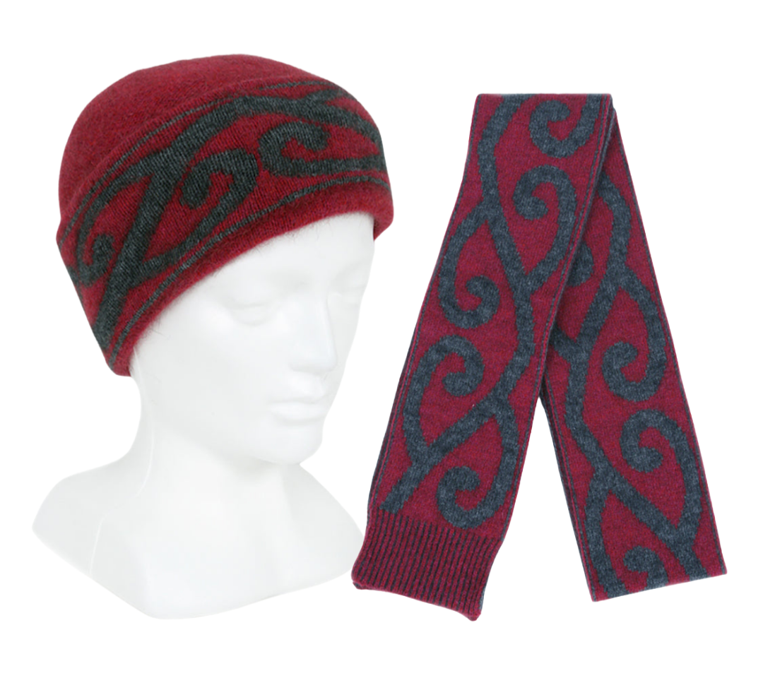 Pink and black patterned hat and scarf set on a mannequin head and white background