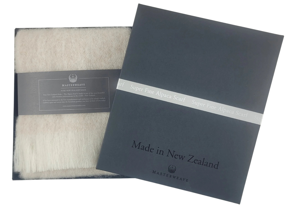 Woolen scarf and packaging with 'Made in New Zealand' text on a white background Main image