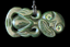 A carved green jade pendant with iridescent inlay, featuring a stylized figure with eyes and a hanging cord, shown against a solid black background.