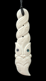 White carvings with blue stones on a black background
