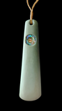 White pendant with a central colorful stone on a black background