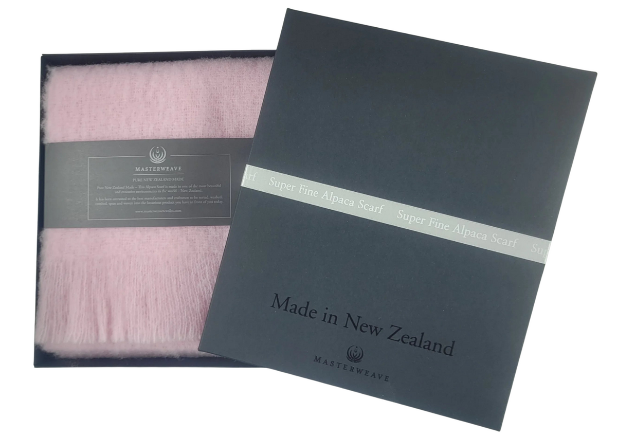 Pink scarf in a black box with 'Made in New Zealand' label Main image