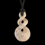 Stone pendant with a black cord on a white background