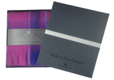 Purple scarf with packaging and 'Made in New Zealand' label on a white background