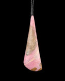 A teardrop-shaped pink and brown polished stone pendant hanging from a black cord against a solid black background.