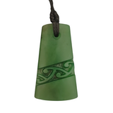 Green pendant with intricate design on a white background